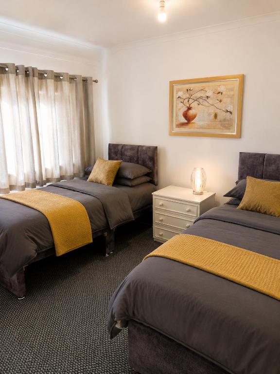 Bedroom with two single beds that zip together into a double